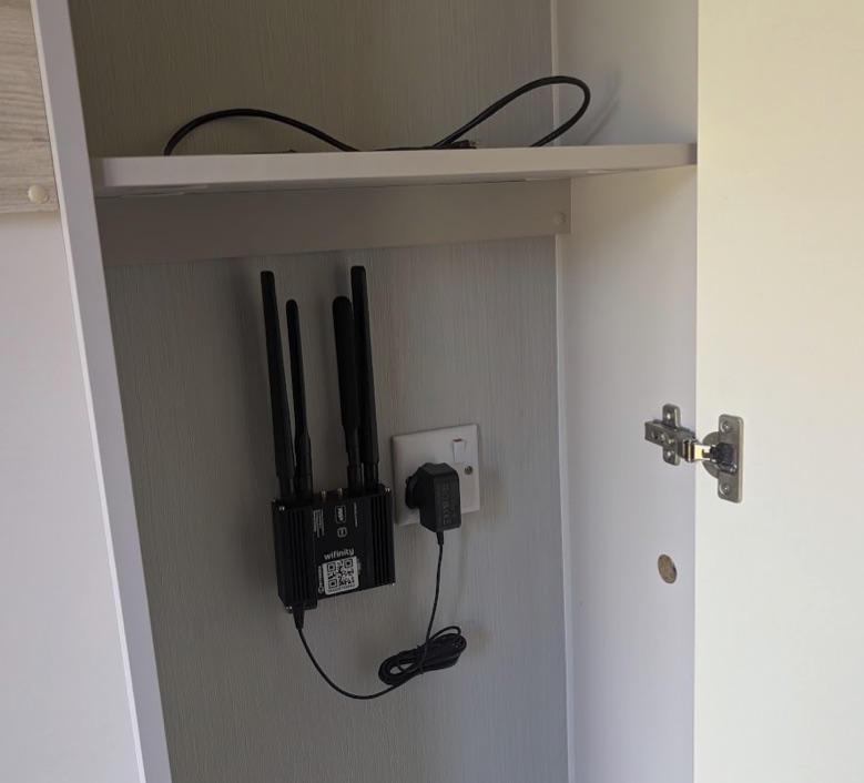 A Wifinity 5G unit mounted inside a cupboard in a holiday home